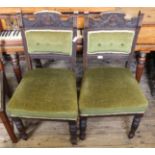A pair of Edwardian oak upholstered dining chairs