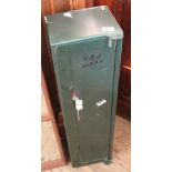 A green painted locking metal storage cabinet