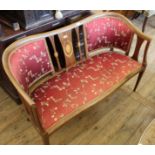 An Edwardian inlaid satinwood saloon settee with red silk floral upholstery
