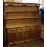 A modern pine shelf back kitchen dresser