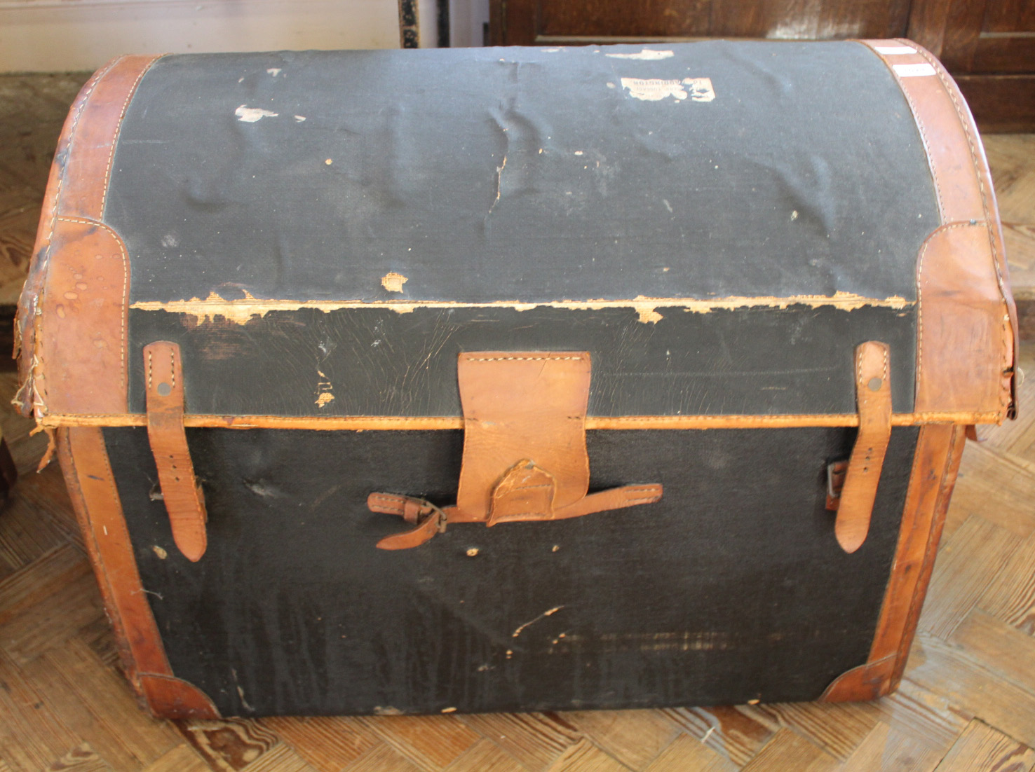 A vintage leather domed top travelling trunk