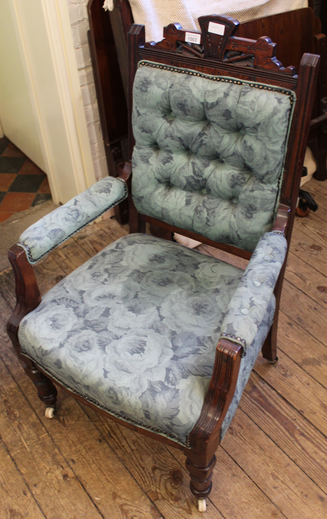 An Edwardian carved mahogany upholstered armchair