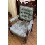 An Edwardian carved mahogany upholstered armchair
