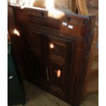 A 19th Century oak and mahogany hanging corner cabinet with two doors and single drawer