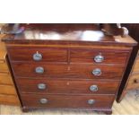 A Georgian inlaid chest of two short and three long drawers with original plate handles and ogee