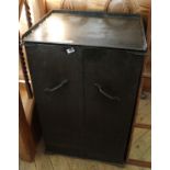 A vintage two door painted metal cabinet with shelved interior