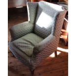 An Edwardian upholstered wingback armchair