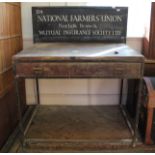 A vintage metal and pine trading stand with National Farmers Union logo on upstand