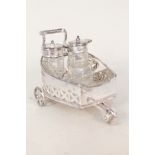 A silver plated wheeled cruet