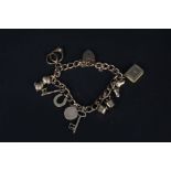 A 9ct gold charm bracelet with ten 9ct gold charms including animal themed