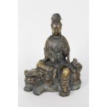 A Chinese bronze of a female deity seated upon a kylin, seal marks,