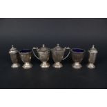 A six piece silver cruet set with Celtic band decoration,