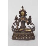 A Tibetan seated Buddha bejewelled with turquoise and other stones,