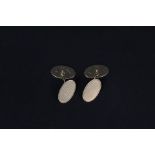 A pair of 9ct gold oval cufflinks with engine turned decoration