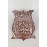 A large Arts and Crafts flower embossed copper wall pocket with shaped back plate,