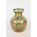 A continental green glass vase with gilt and red decoration,