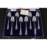 A boxed set of eight silver teaspoons commemorating Silver Jubilee with flower design to back of