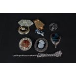 Two large stone set silver mounted pendants and a quantity of costume brooches,