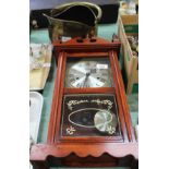 A modern wall clock plus a brass coal helmet