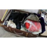 A trunk containing vintage clothing and hats etc including a mauve velvet childs waistcoat
