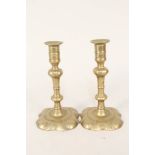 A pair of 18th Century seamed brass candlesticks by Joseph Wood with knopped stems and petal shaped