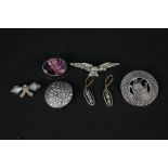 Five silver brooches, one with Viking ship decoration,