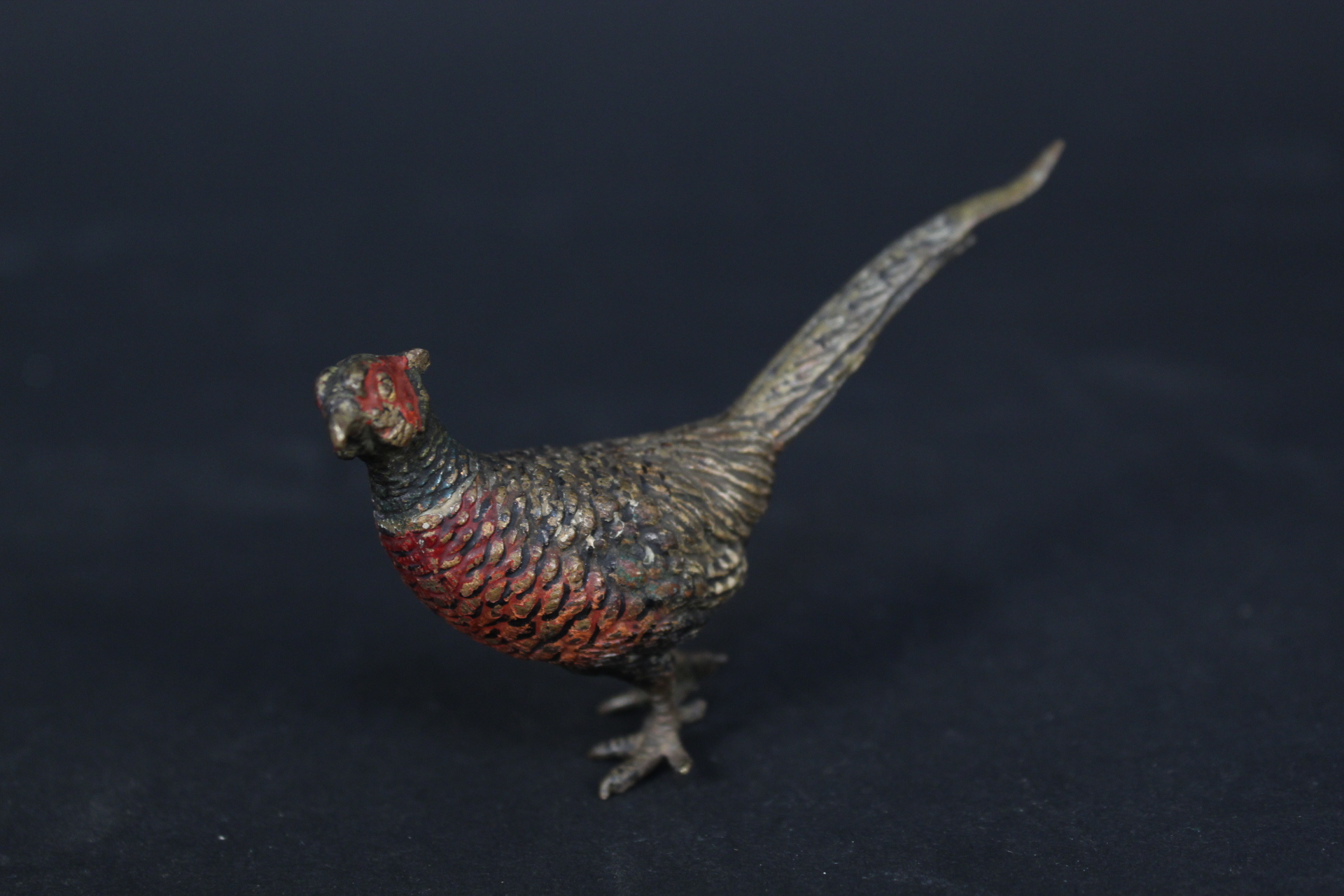 A cold painted model of a pheasant