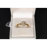 A 22ct gold ring with seed pearl and diamond cluster, the band has ornate rope decoration,