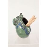 A Brannam green glazed caricature toothpick holder