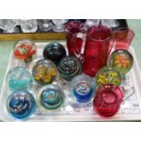 Various glass paperweights plus Victorian cranberry glass