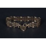 A 9ct gold gate link bracelet with heart shaped padlock clasp
