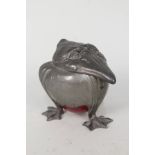 A pewter inkwell in the form of a grotesque bird with maroon pottery base