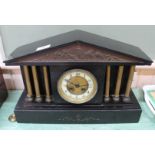 A black marble striking mantel clock