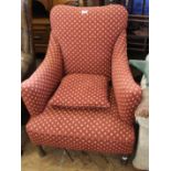 A 1930's upholstered armchair with red and gold fabric