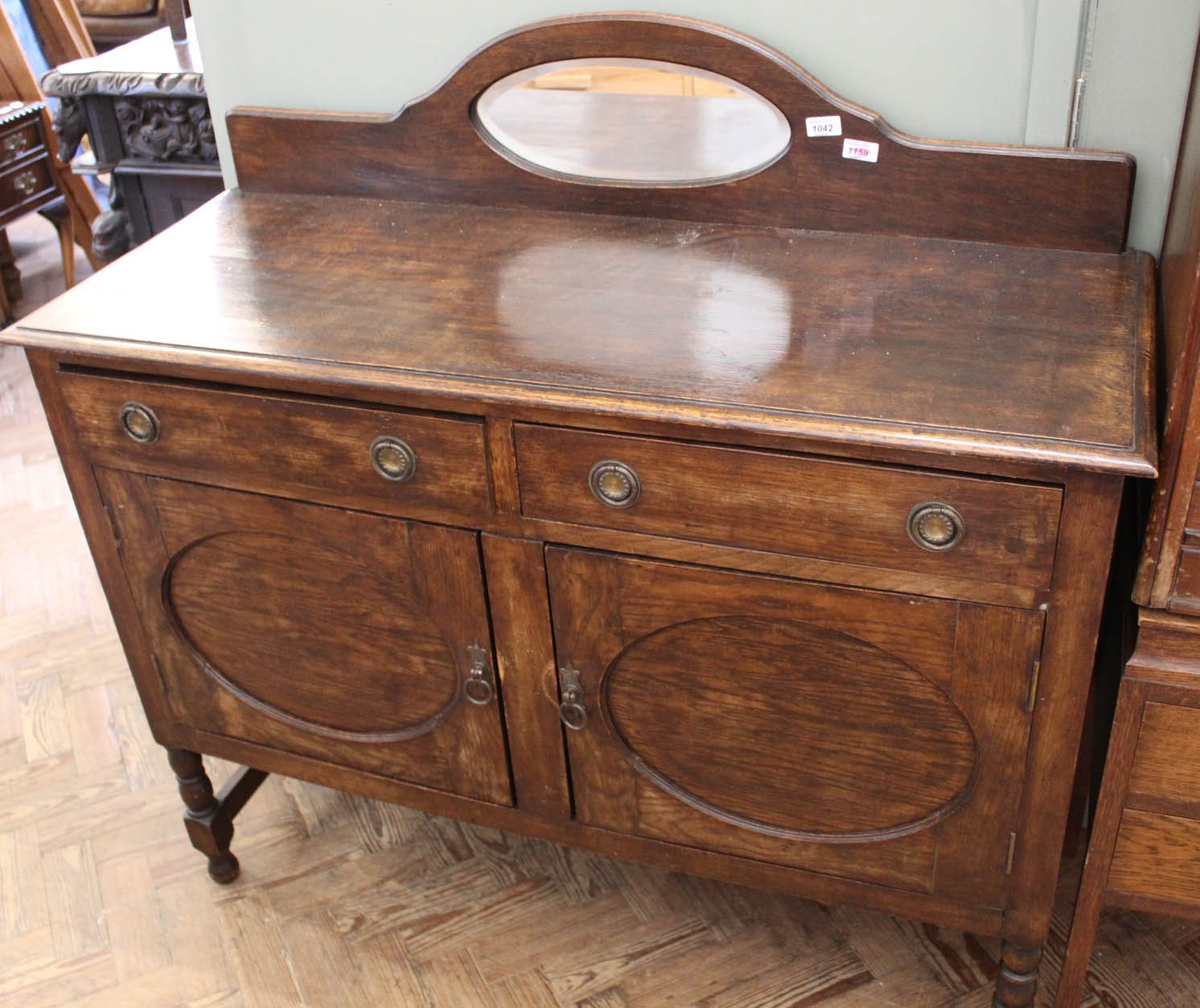 A Victorian oak two door two drawer mirrored sideboard