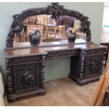 A substantial early Victorian extensively carved mirrored sideboard