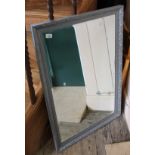 A modern bevelled mirror with silvered frame