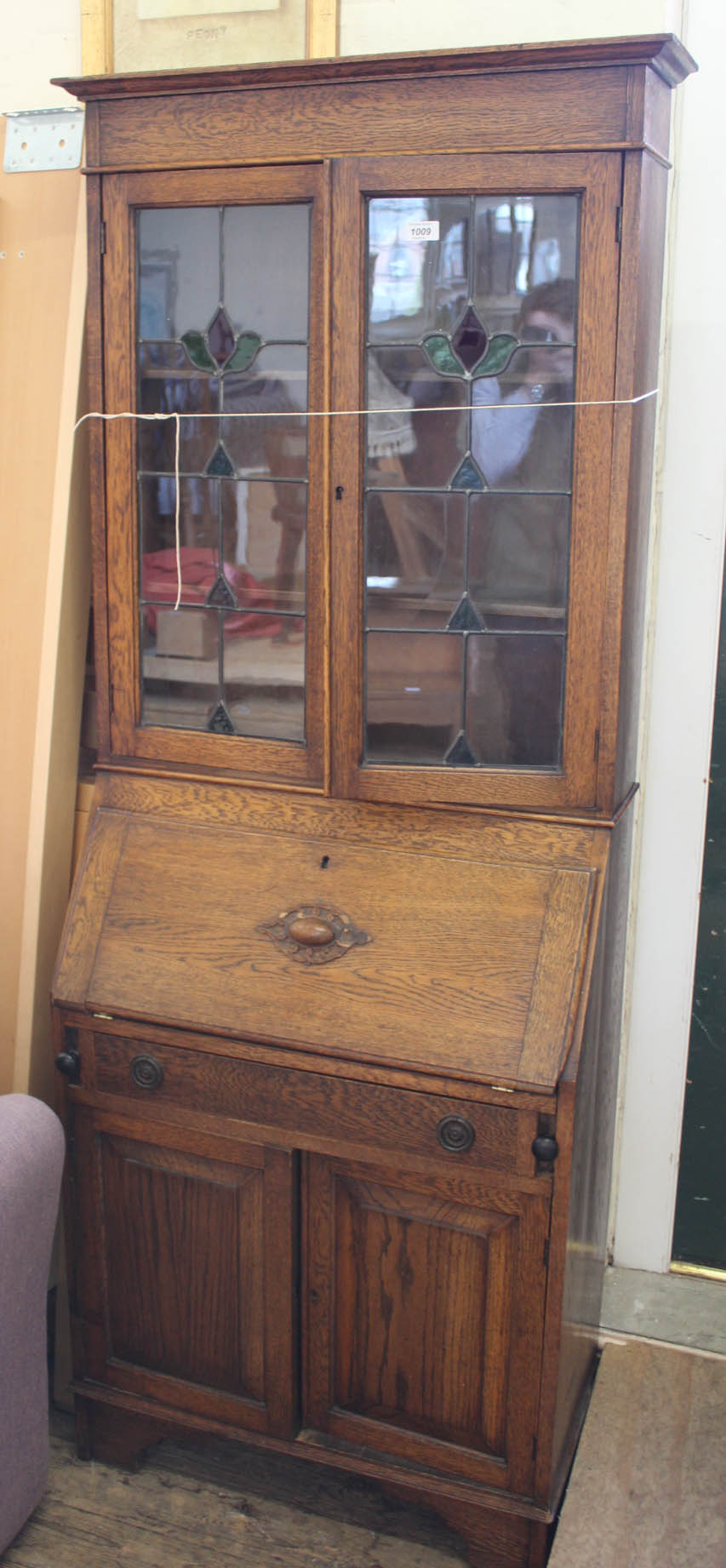 A 1920's oak bureau bookcase with stained glass