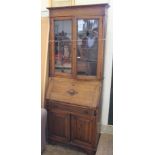 A 1920's oak bureau bookcase with stained glass