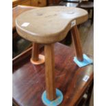 An oak three legged milking stool