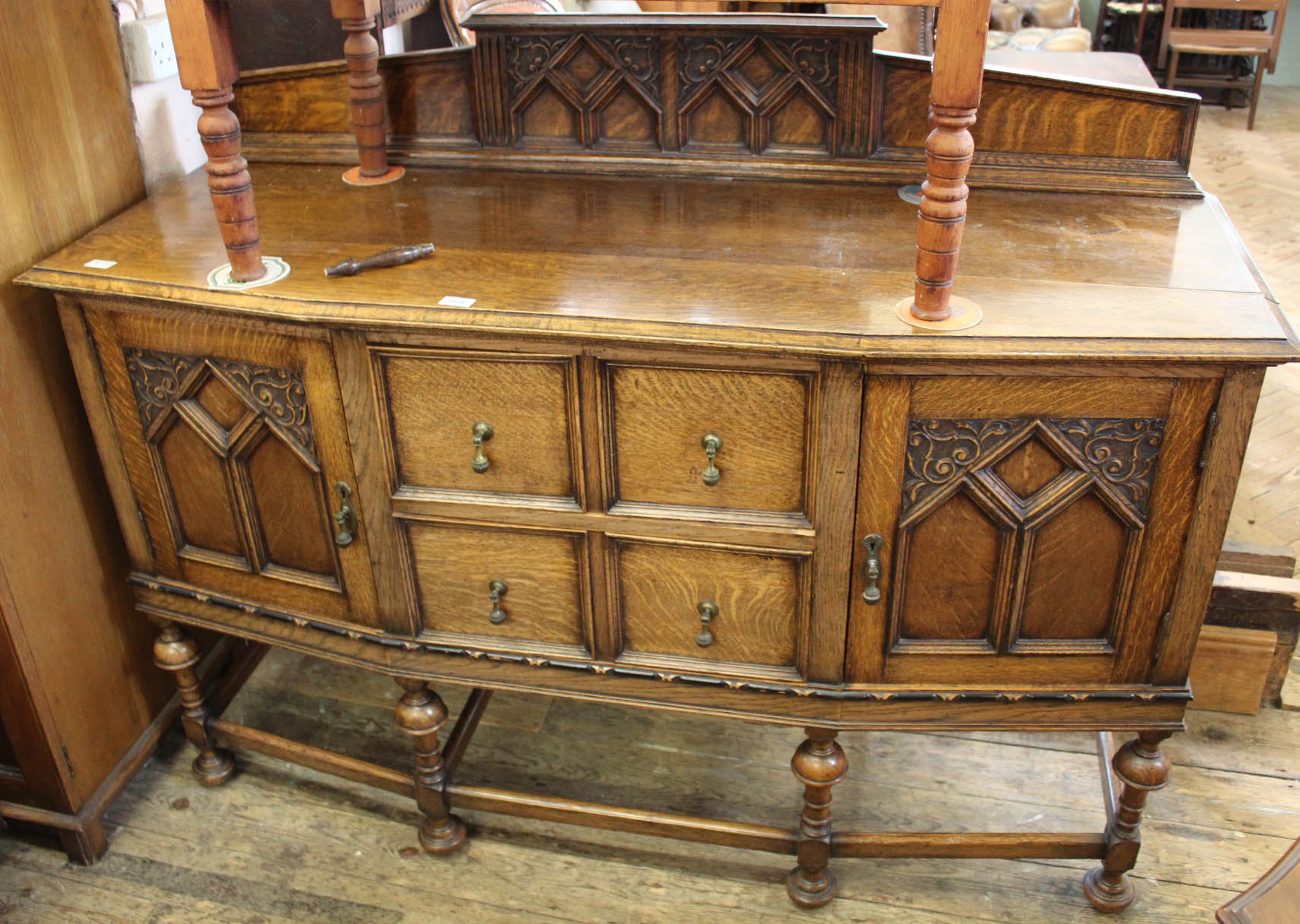 A good quality carved Edwardian oak sideboard on stretcher legs