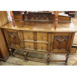 A good quality carved Edwardian oak sideboard on stretcher legs