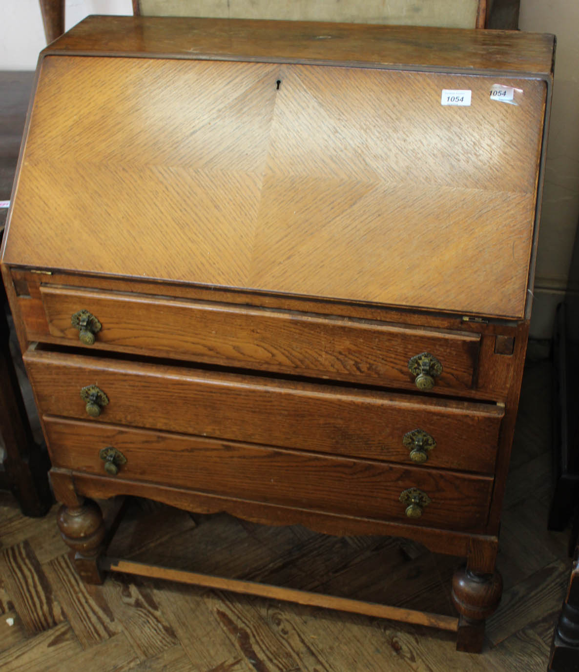 A 1940's oak three drawer bureau
