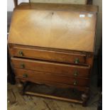 A 1940's oak three drawer bureau