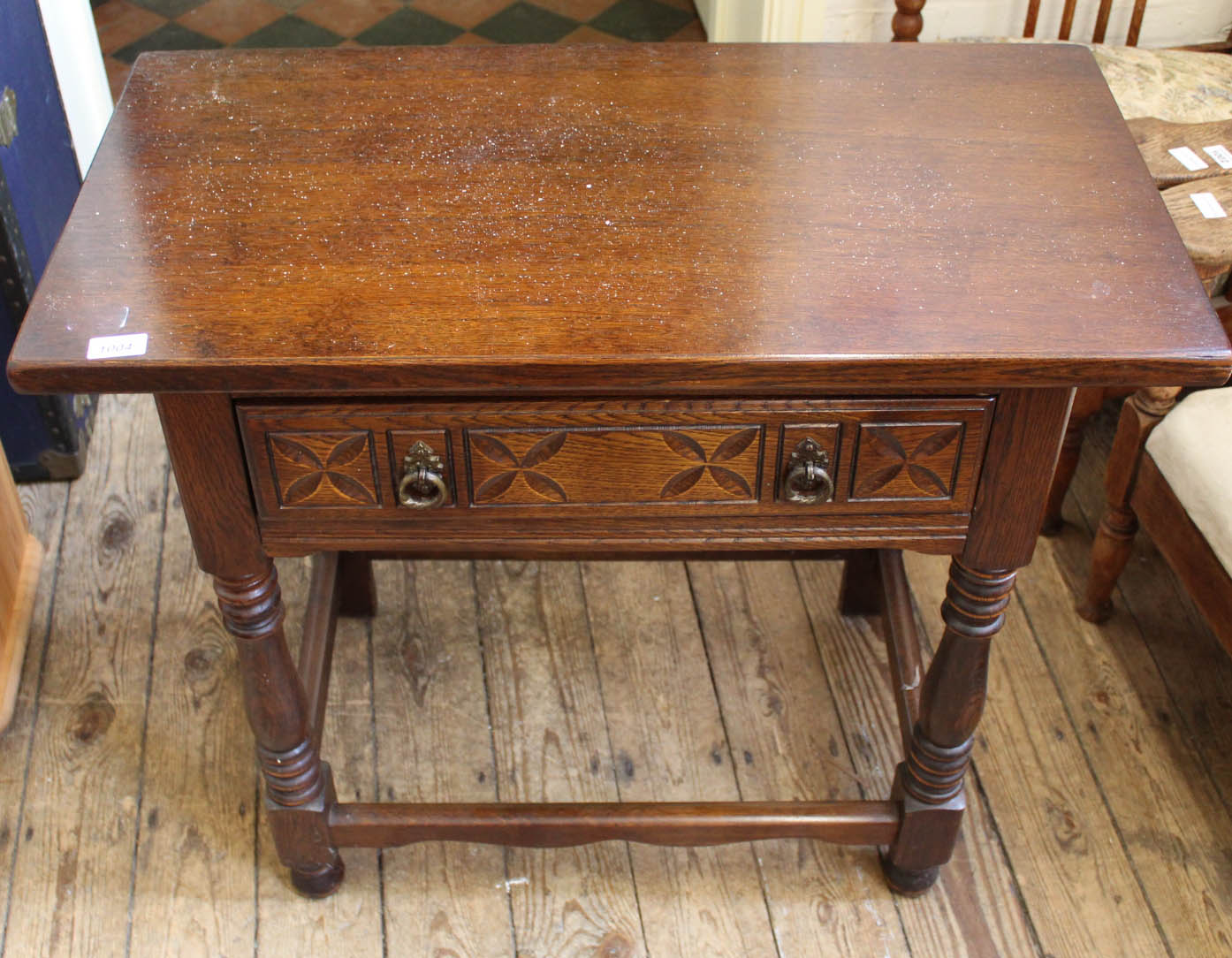 A Robertson and Coleman carved oak side table with one drawer