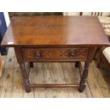 A Robertson and Coleman carved oak side table with one drawer