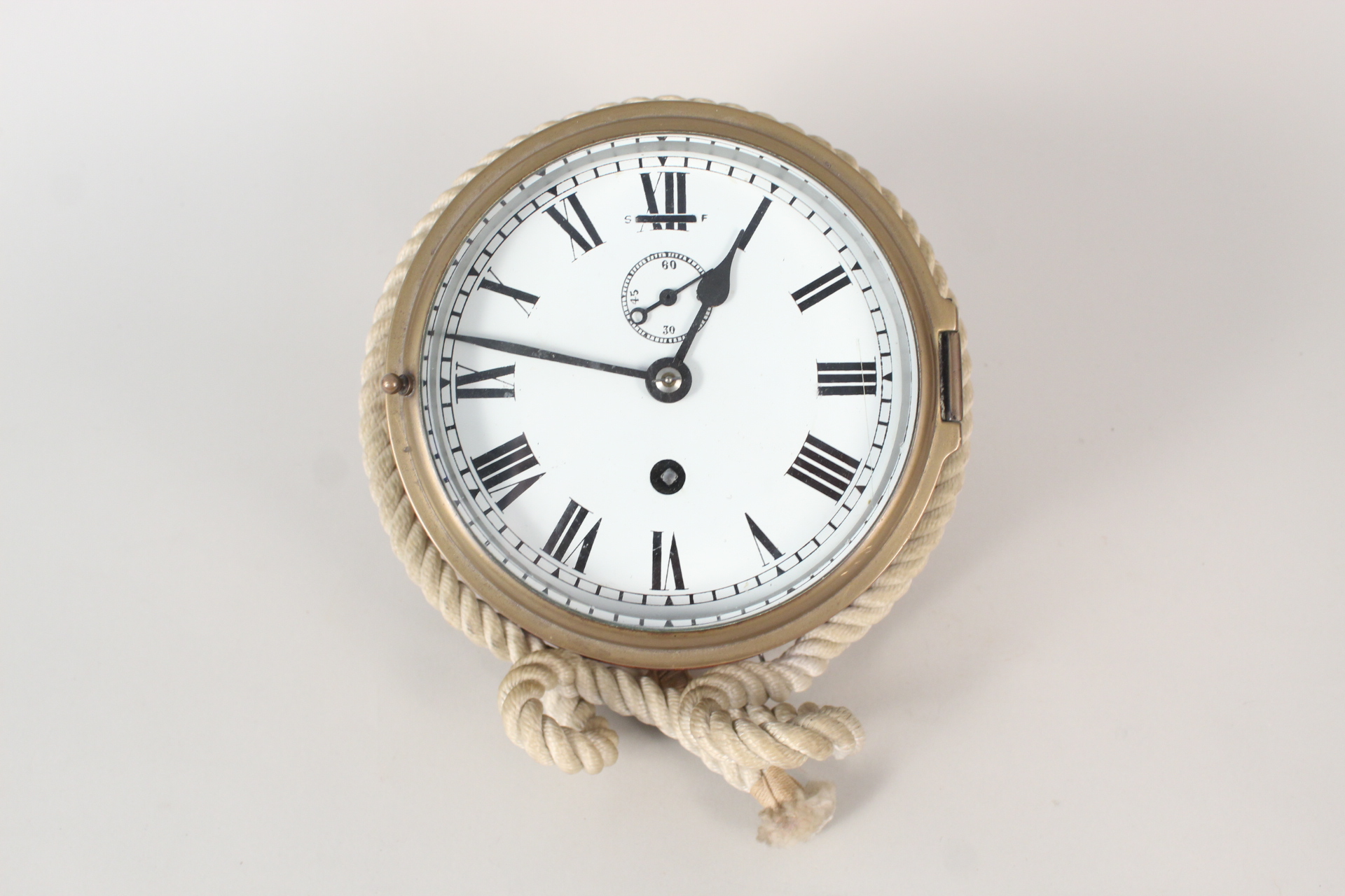 A brass ships clock with rope surround