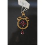 A 9ct gold Art Nouveau style pendant set with pink stones