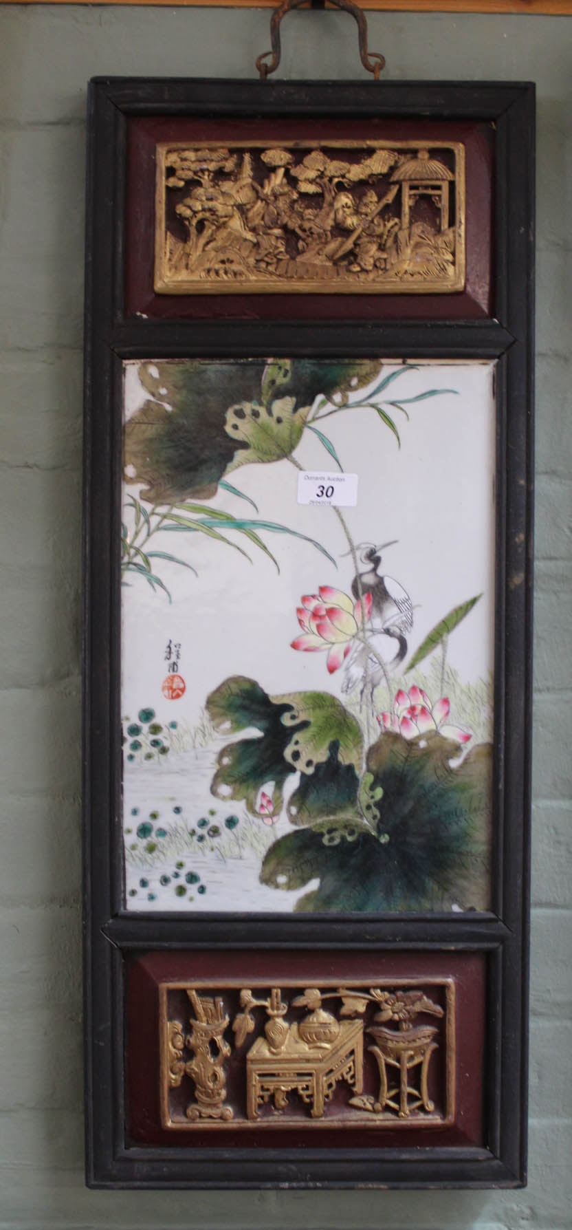 A Chinese carved wood parcel gilt panel with bird and floral porcelain panel,