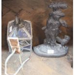 A Victorian iron man and dog doorstop plus a leaded porch lantern